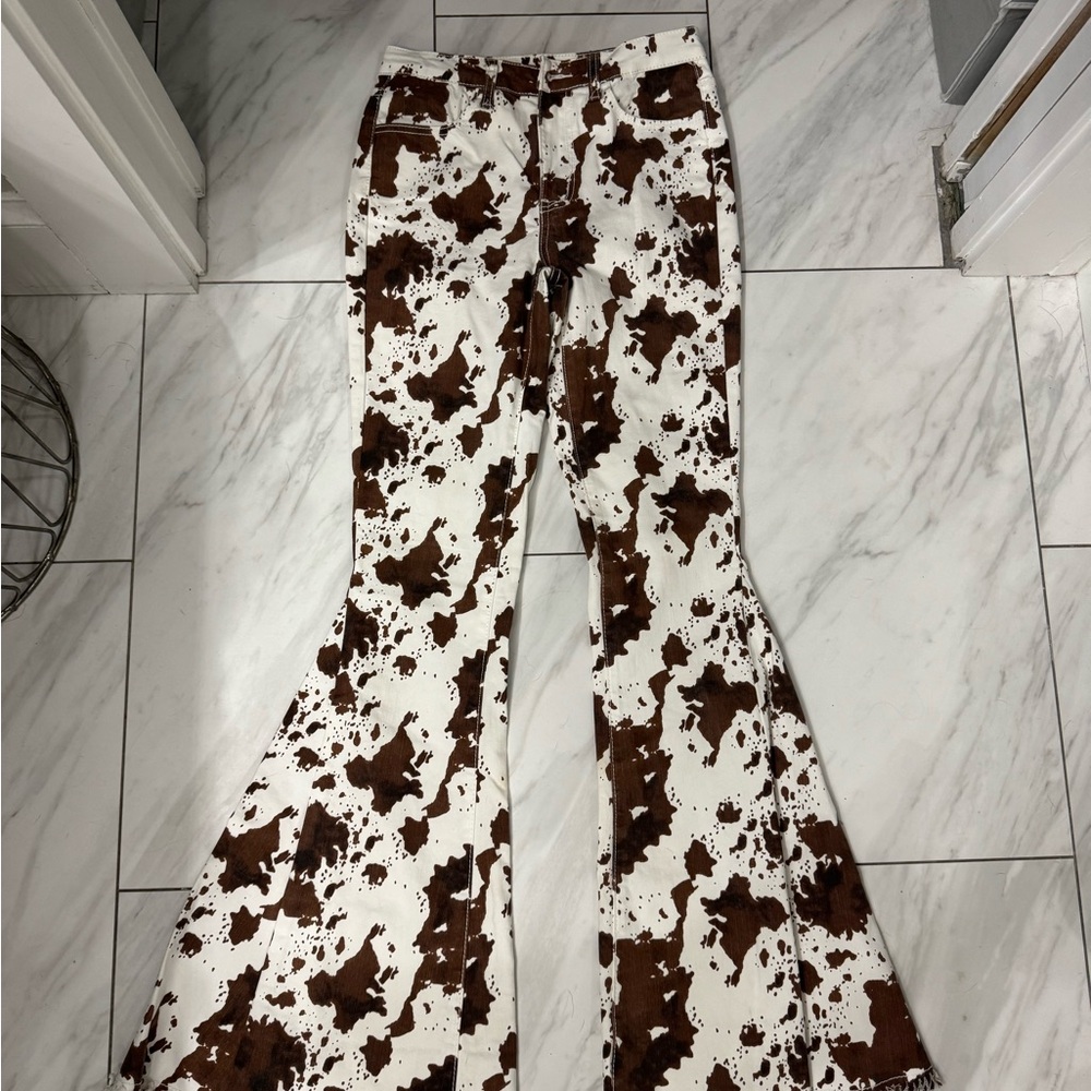 Size small Buckle Saints & Hearts cow print bell bottoms